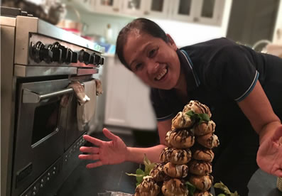 Filipina housekeeper with cake